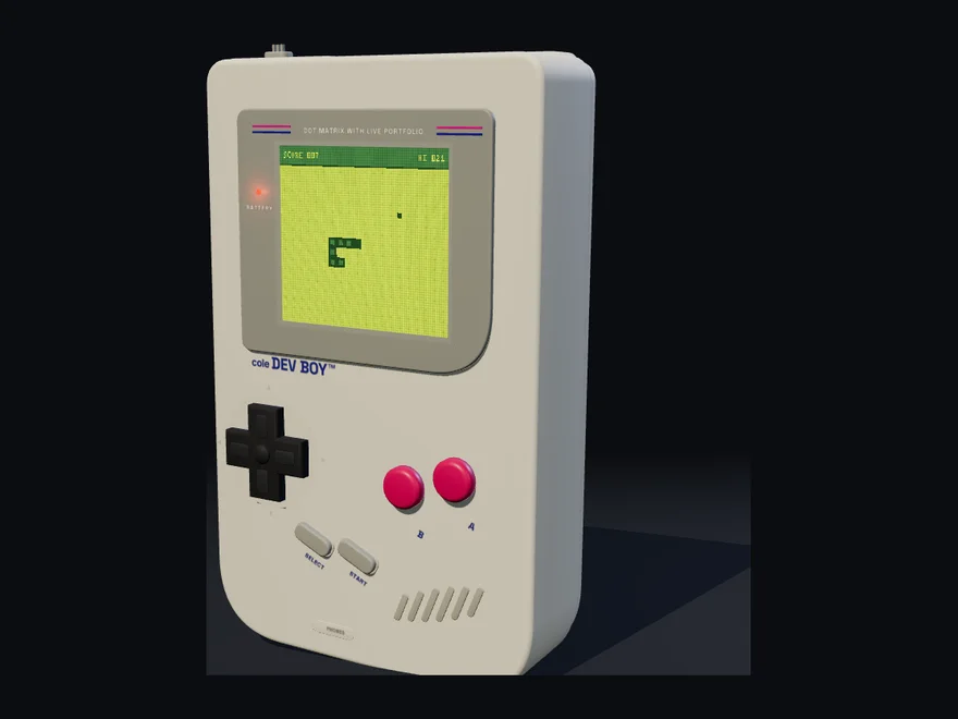 The Coleboy Mk II at a three-quarter angle, grey shell and dished D-pad.
